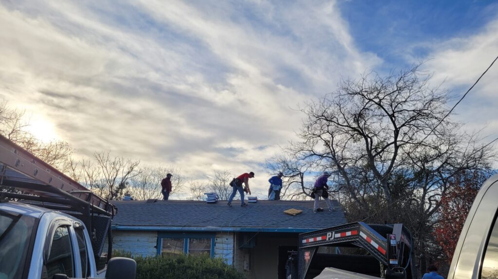 roofers on top of a house